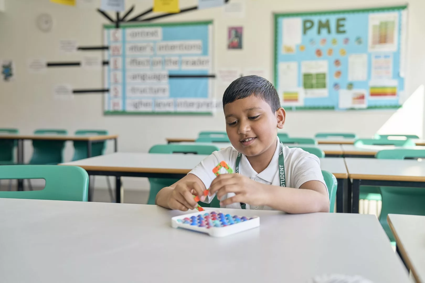 Smiling young boy in a classroom