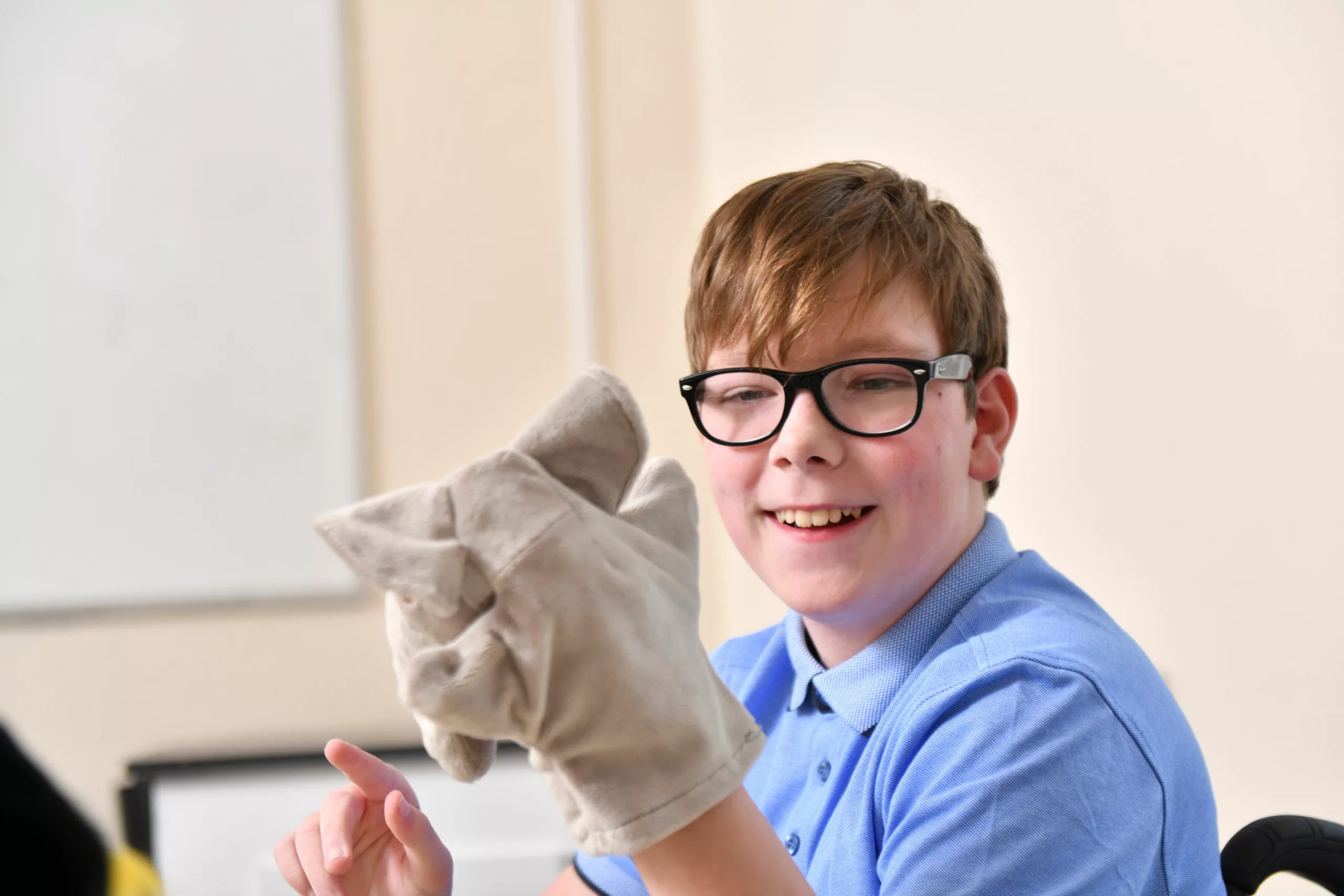 Boy playing with hand puppet