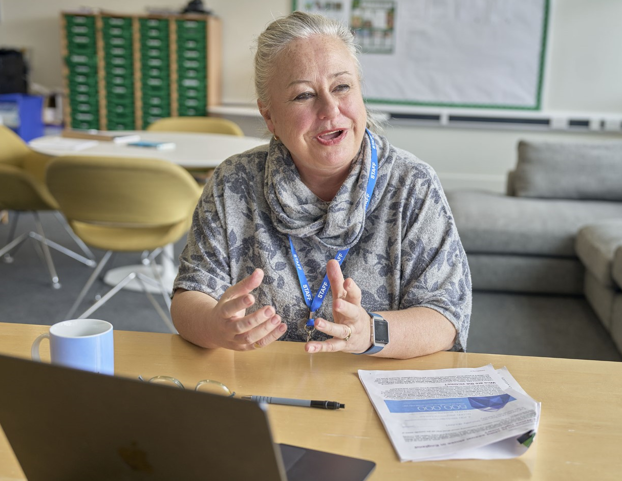 Female professional presents to laptop in office setting