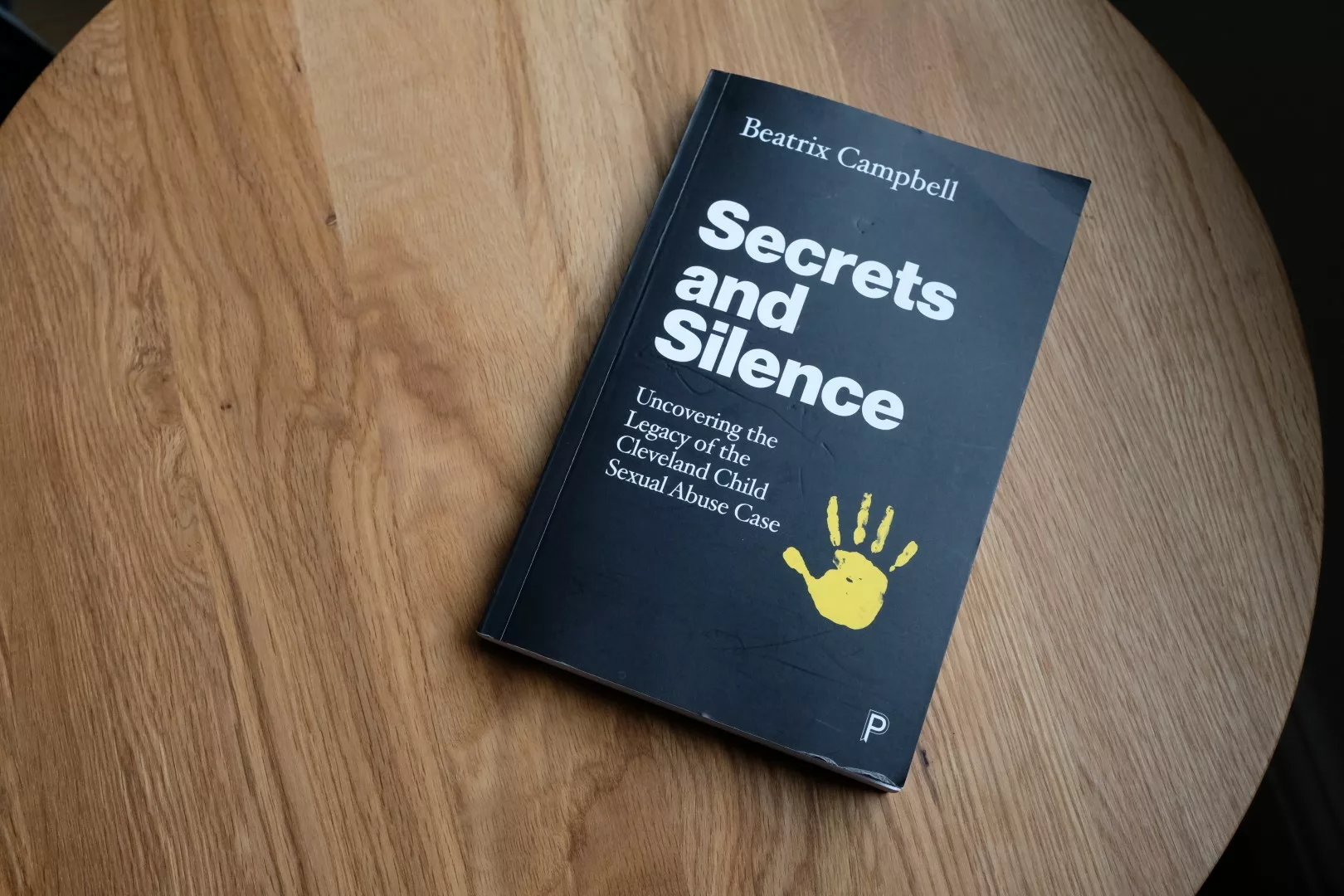 Cover of Secrets and Silence book on a table