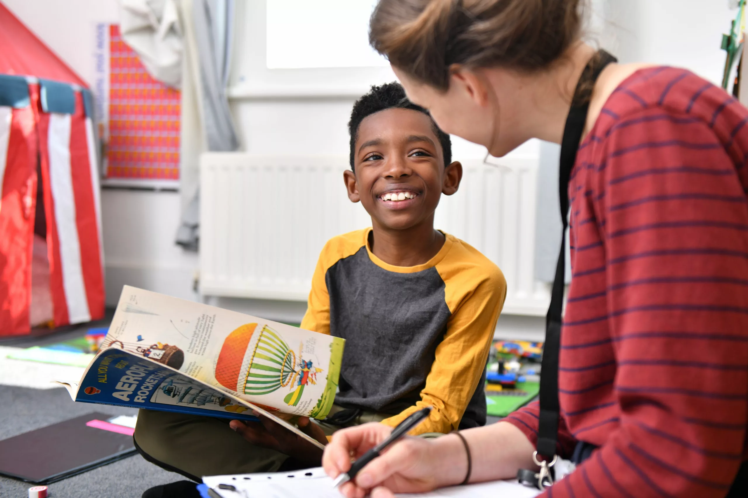Young boy speaking to a social worker during a home visit